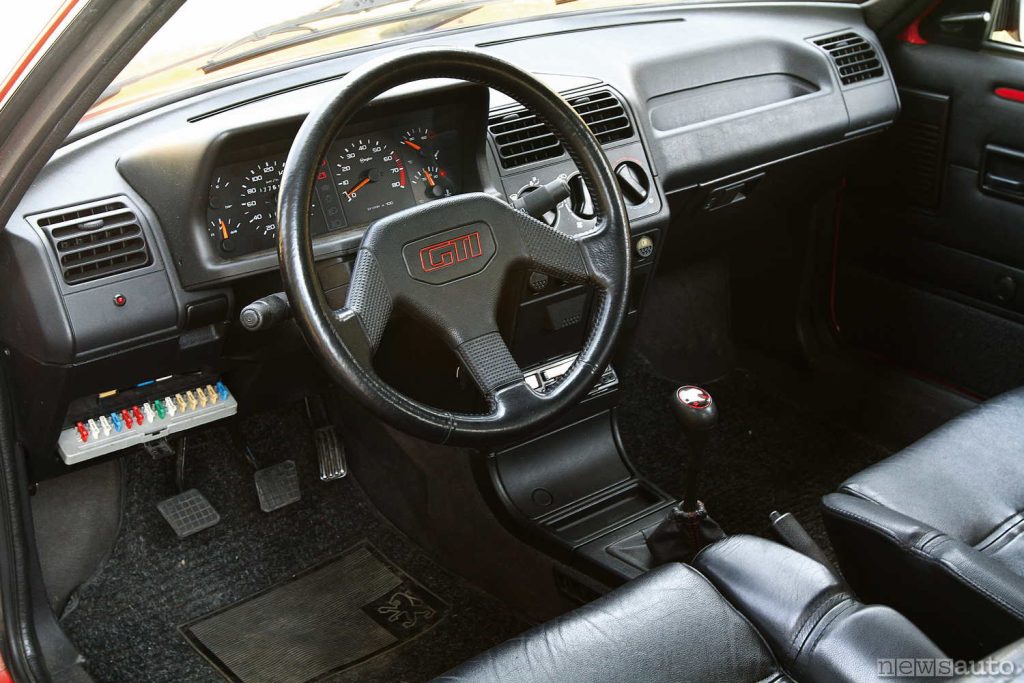 Cockpit, interior, seats of the Peugeot 205 GTI with the classic Peugeot sports steering wheel